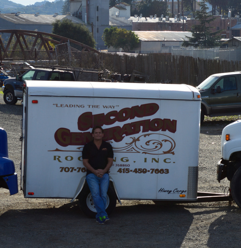 Dale Daniels beside the company trailer